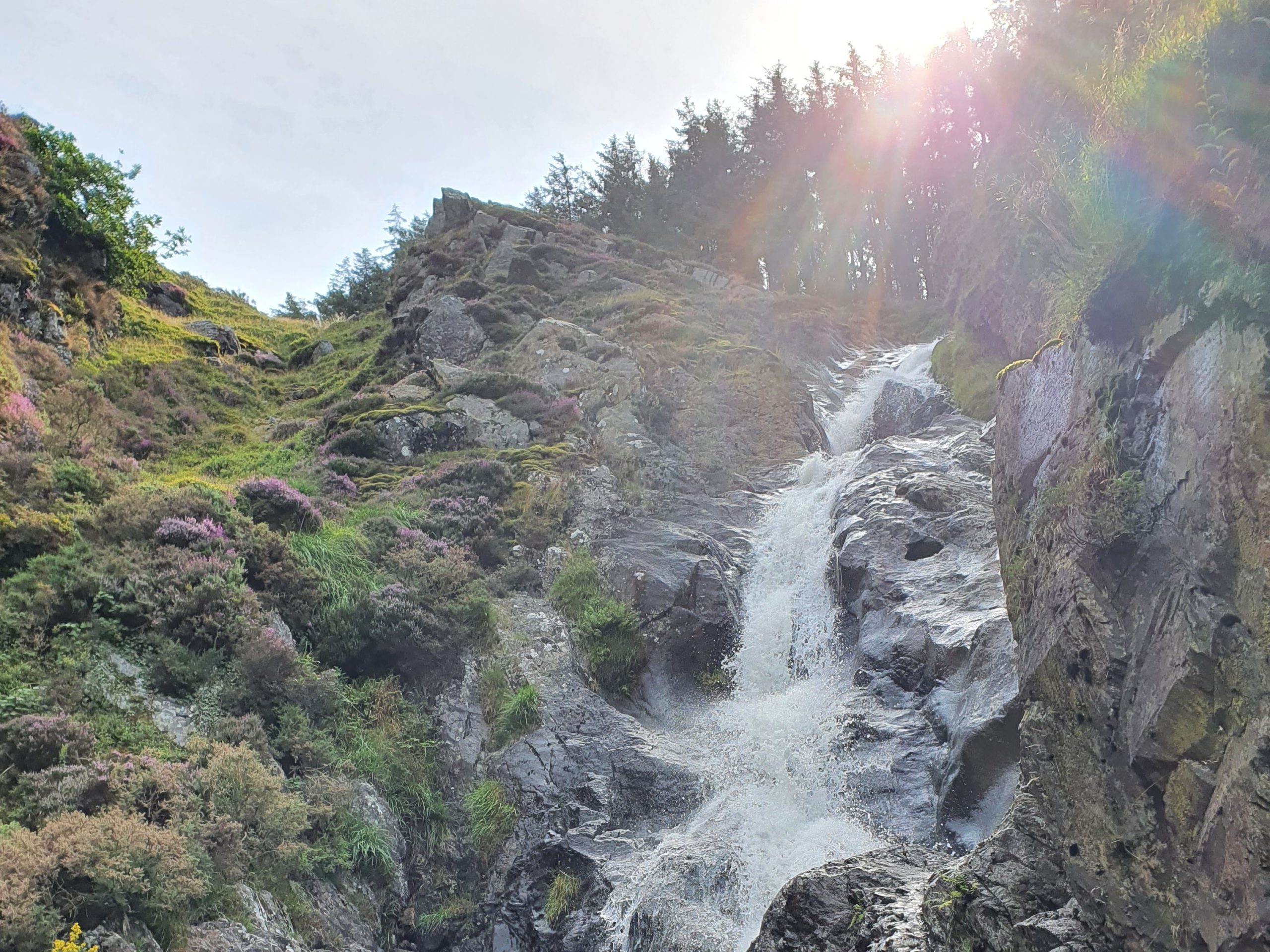 A waterfall with the sunshine in view